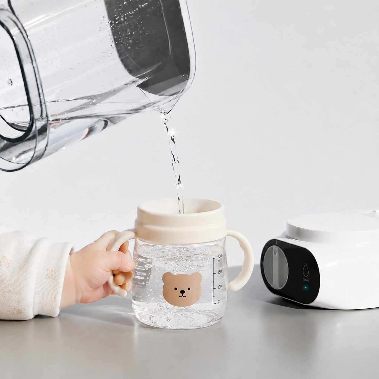 A child drinking water poured from the SFLUX pitcher